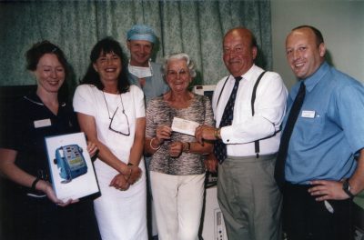 Helen Liwicki receiving funds raised at a 2002 barbeque.